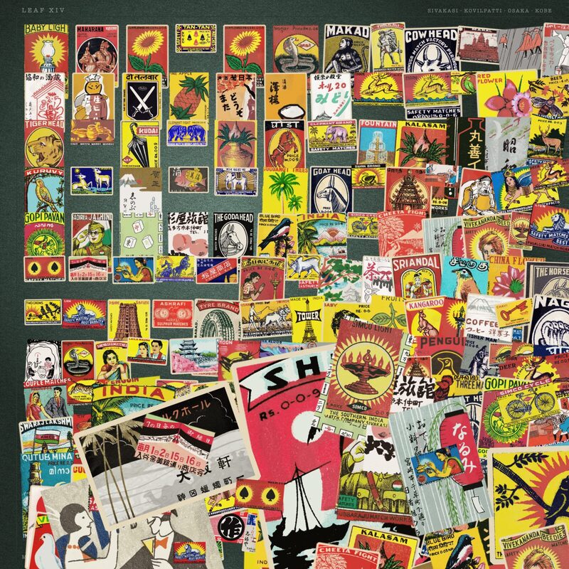 A square sheet packed with hundreds of vintage Indian and Japanese matchbox labels, tidy rows in one corner decaying into an overlapping pile